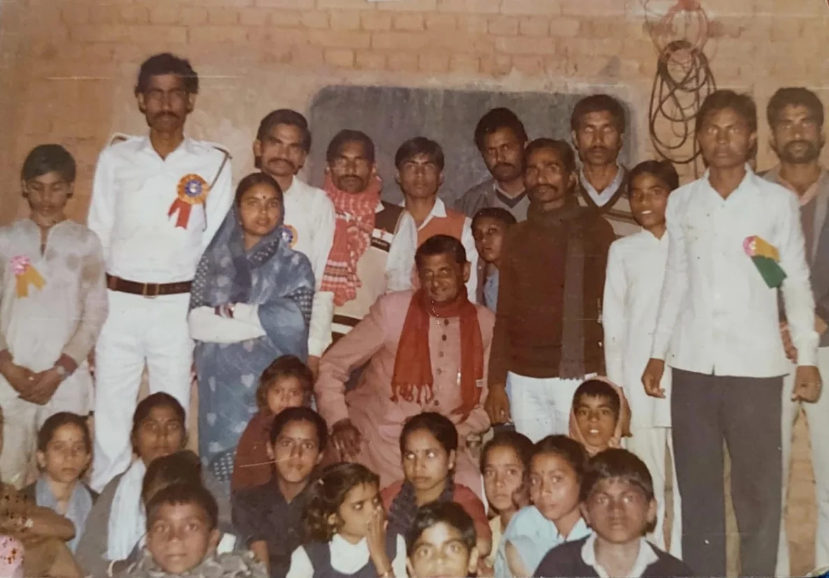 An archival gathering of community members and children