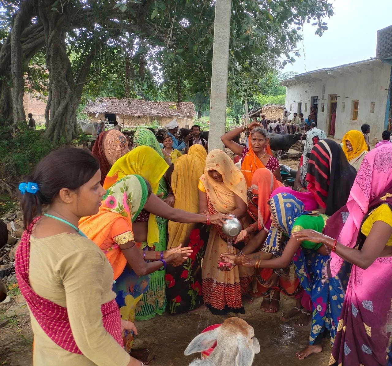 Women gathering during a community cleanliness and water activity
